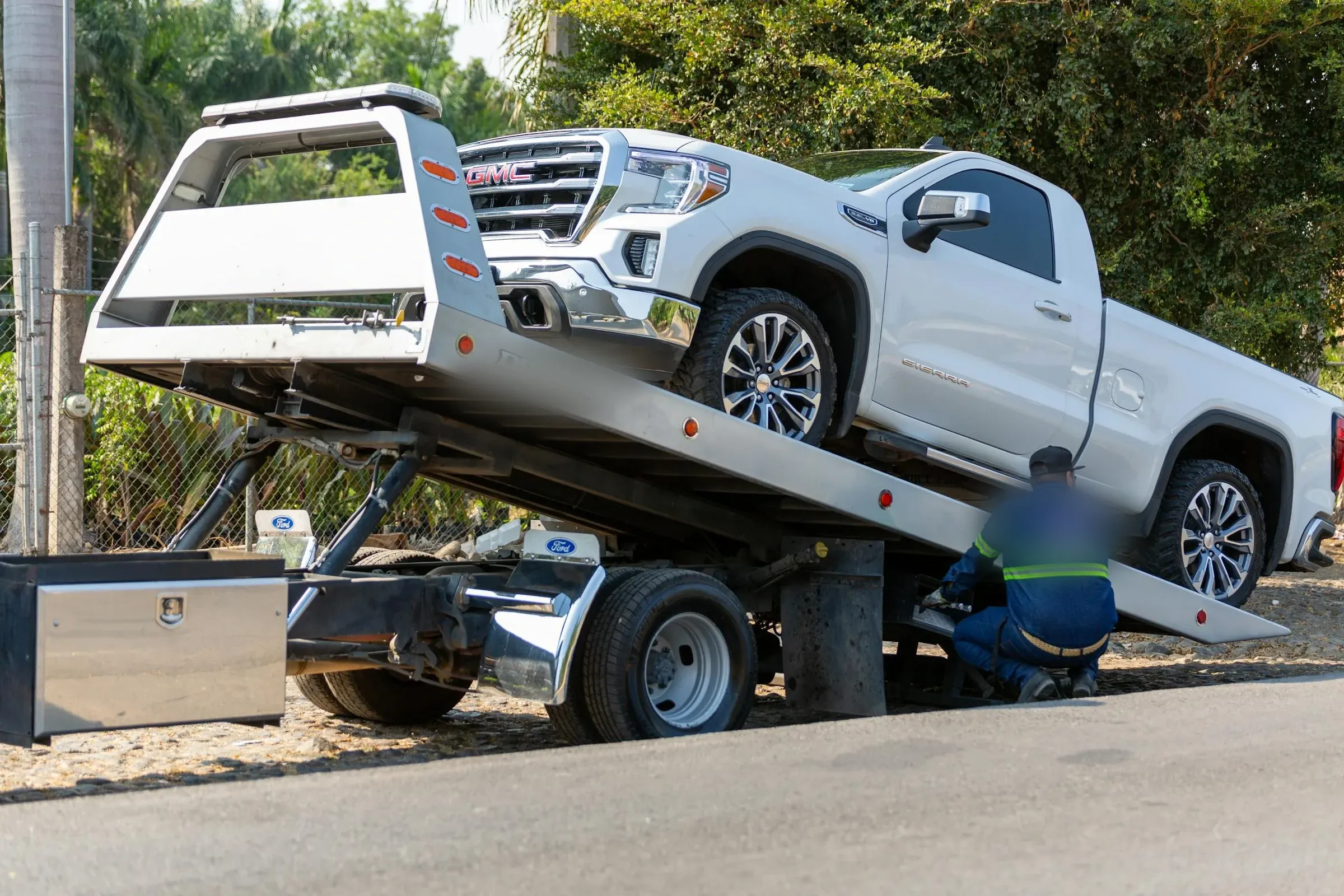 Safelane Towing operator loading a pickup onto a flatbed