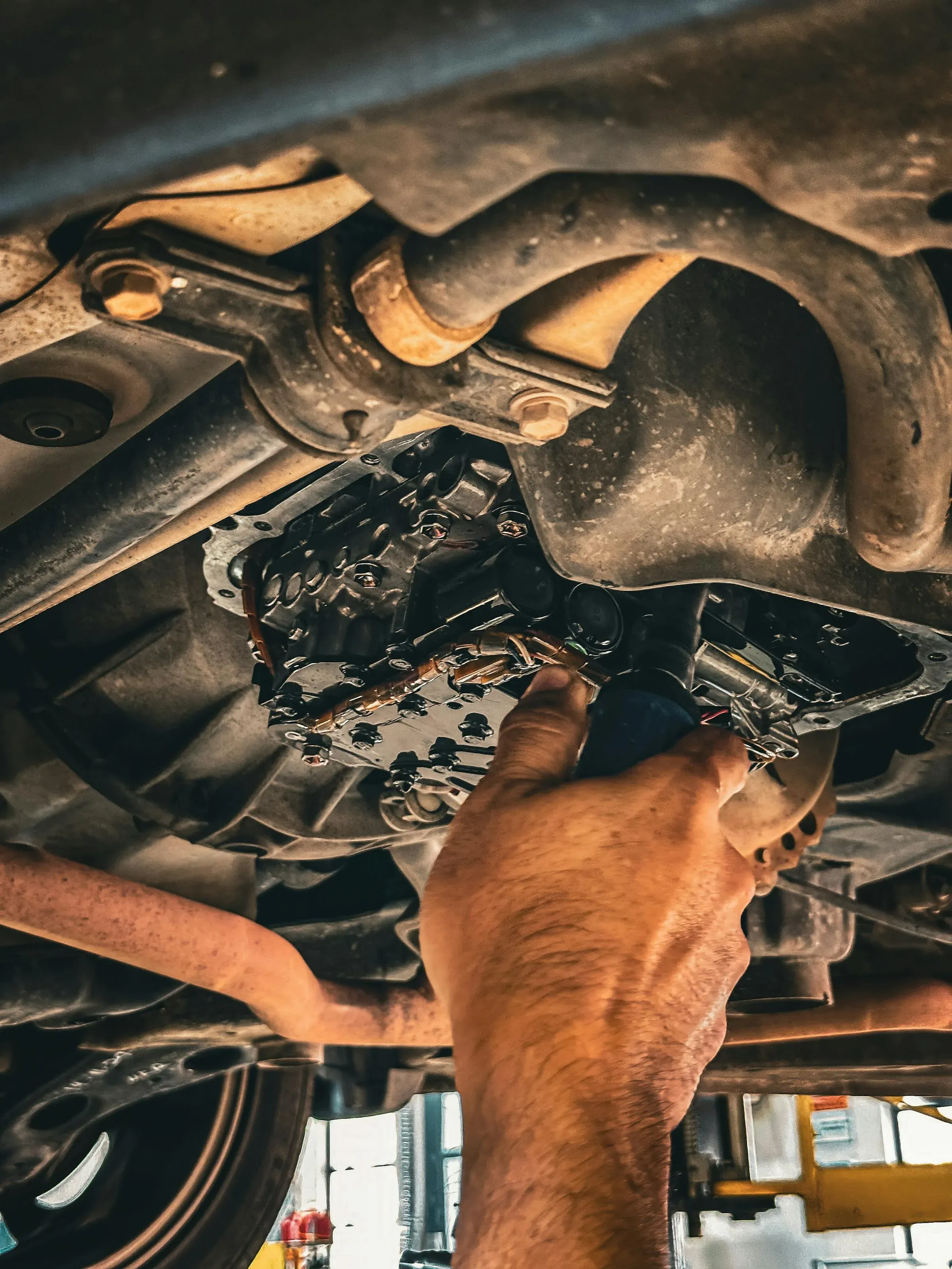 Safelane technician inspecting the underside of a vehicle
